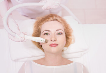 Beautician makes facial massage girl. Lymphatic drainage massage LPG, apparatus process. Beauty...