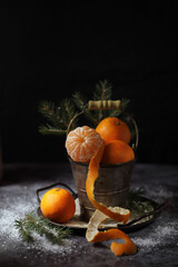 Still life with fresh tangerines in a vintage bucket in retro style.