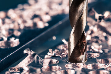 Metal copper drilling with shavings. Close-up of metallic workpiece 