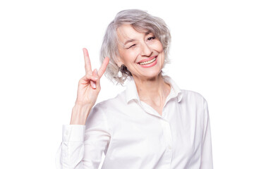 Close up portrait of senior grey-haired woman wearing elegant shirt standing over isolated white...