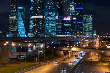 Fototapeta na wymiar night city skyscrapers business center traffic transport lights urban vibe