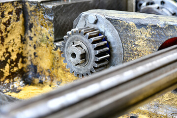 Transmission gear and splined shaft of a metalworking machine under repair.