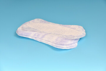 Sanitary pads for women on a blue background.