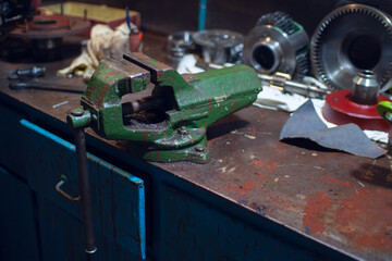 An old green vise in a locksmith's workshop.