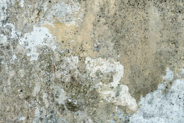 The surface of a concrete wall with old peeling paint. The texture of time-damaged paint. Multi-colored blank background for the design.