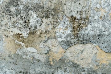 The surface of a concrete wall with old peeling paint. The texture of time-damaged paint. Multi-colored blank background for the design.