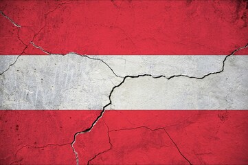 An image of the Austria flag on a wall with a crack.