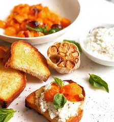 Orange tomato and roasted garlic crostini