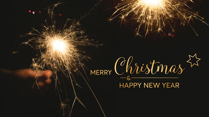Christmas and new year greeting card with burning sparklers on night sky. Background for merry christmas and new year wishes for english greeting card or banner.