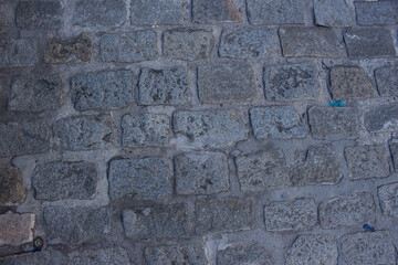 gray texture of cobblestones surrounded by cement