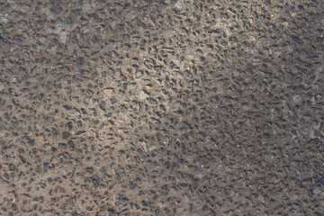 gray texture of pebbles surrounded by cement