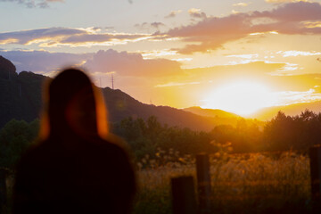 Silhouette of young teen girl sitting on the bench