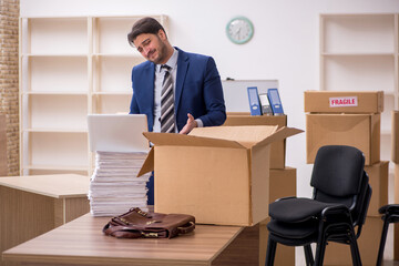 Young male employee in relocation concept