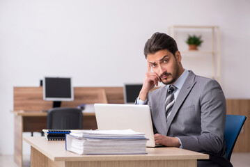 Young male employee working in the office