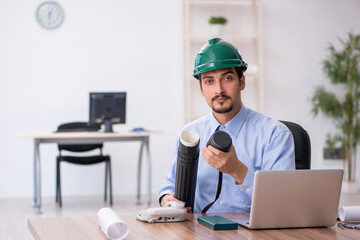 Young male architect working in the office