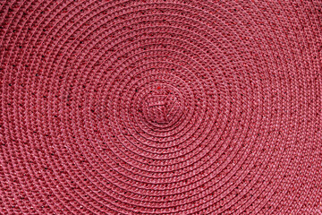 Fototapeta na wymiar abstract background of round pink straw mat with glitter thread close up