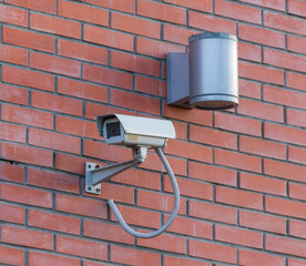CCTV camera on red brick wall