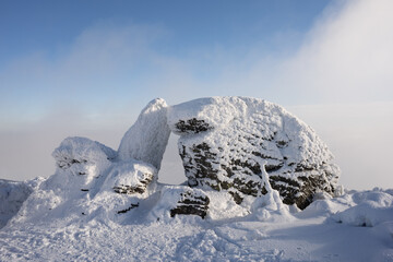 Kamenne okno, Stone window, Jeseniky mountains, Czech Republic, Czechia. Rock formation and landmark is covered by white snow in the winter season and wintertime.  © M-SUR