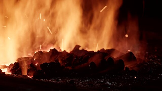 a blacksmith in a forge heats metal in a forge, heavy industry.