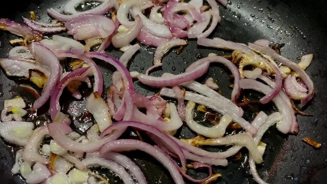 Preparation chopped fried onion in frying pan.
