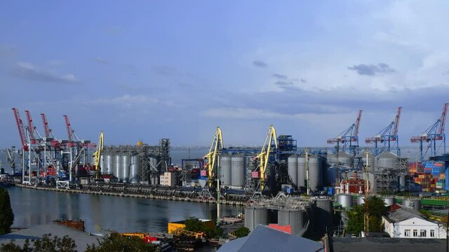Port landscape with moving cargo loaders time laps