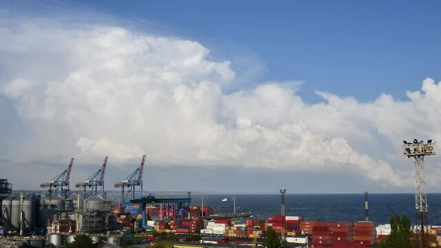Clouds over industrial port skyline time lapse