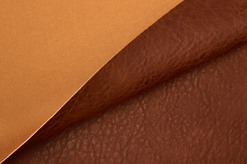Fototapeta premium brown artificial leather with waves and folds on PVC base