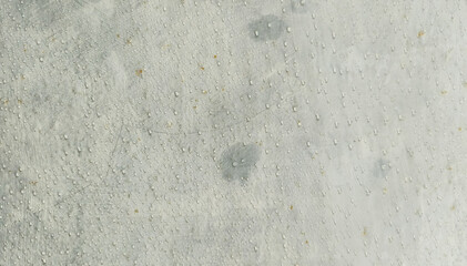 white concrete wall full of water spots
