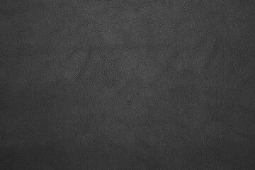 black artificial leather with waves and folds on PVC base
