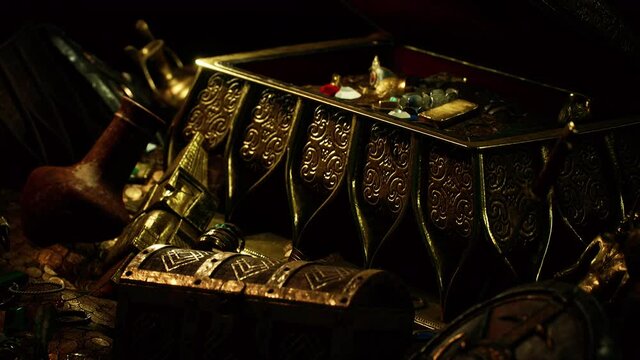 treasures in a dark cave with coins diamonds and gold