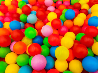 Background of many plastic colorful balls in ball pool in a children's game room
