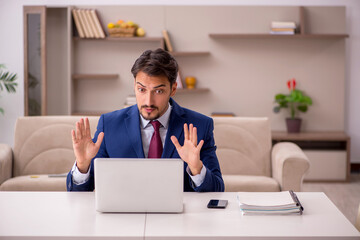 Young businessman working from house