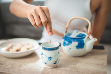 Asian woman person relaxing with hot tea to drink at home, tea cup for happy lifestyle in morning