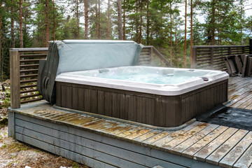 Modern outdoor hot tub on a wooden deck in the cold winter day. Location Salo, Finland.