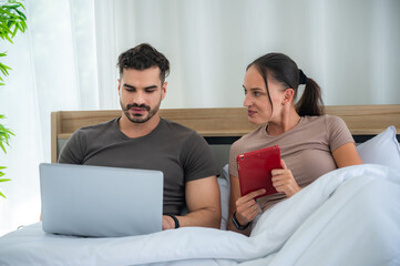 woman and man couple working online with laptop for business work at home, happy indoor lifestyle