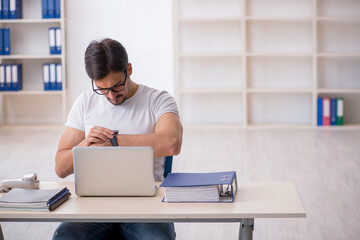 Young male employee freelancer sitting in the office