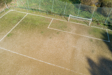Aerial view of the area and the goal of a dirt soccer ground. © VicVaz