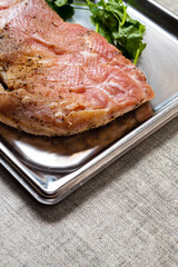 Fresh pork belly slice and green coriander on a metal tray, Meat industry product.