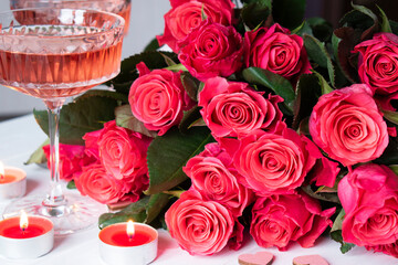 pink roses and glasses with rose and burning candle