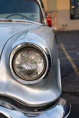 Detail shot of a classic chevy headlight. Vintage car. Classic car. American mucsle. - obrazy, fototapety, plakaty