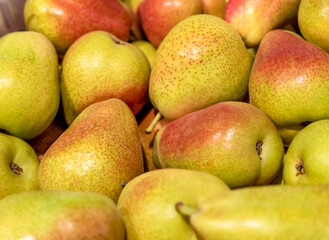 Pears in the store. Juicy pears of red and yellow color with small dots. Healthy lifestyle. Healthy fruits. Selected focus
