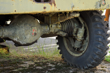 A military truck old with a detail on the front axle.
