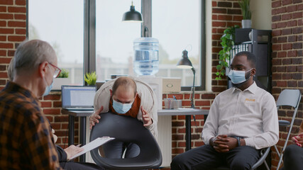 Man with anger management issues having nervous reaction at aa group meeting during covid 19...