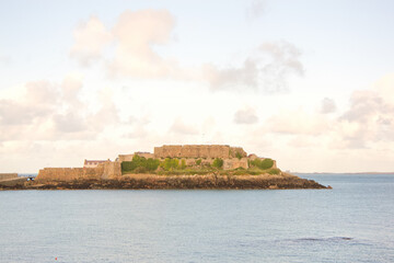 View of Castle Cornet over the sea at sunset, Guernsey