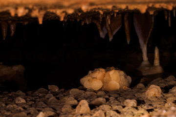 A bunch of crystals in a cave with a dark background.