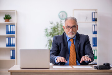 Old boss working in the office