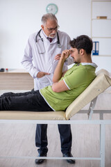 Young male patient visiting old male doctor