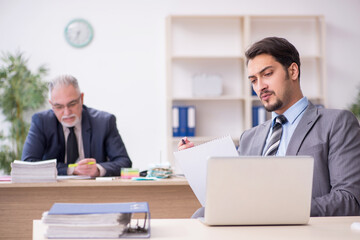 Two male employees working in the office