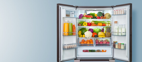 different fruits and vegetables in a open fridge. frozen food storage background.