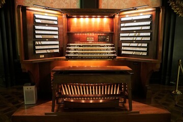 A traditional pipe organ illuminated with lights - obrazy, fototapety, plakaty